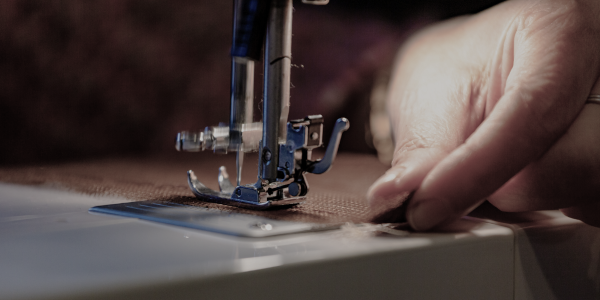 Artisan's hands on a traditional loom, weaving with vibrant threads, embodying the crafting of stories and dreams.